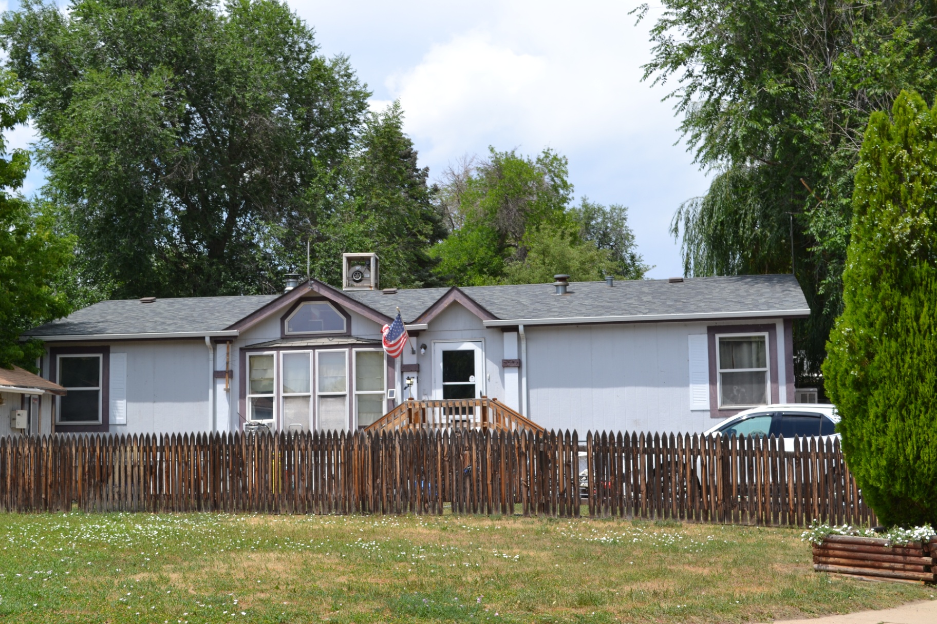 The gabled gray — Twin gables and vaulted windows overlook a wide, quiet front lawn.